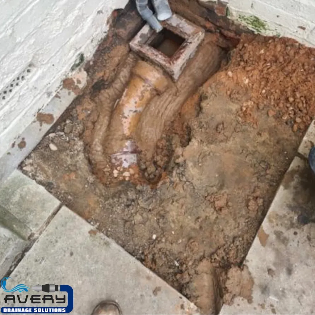 Excavated drain pipes and manhole during drainage repair