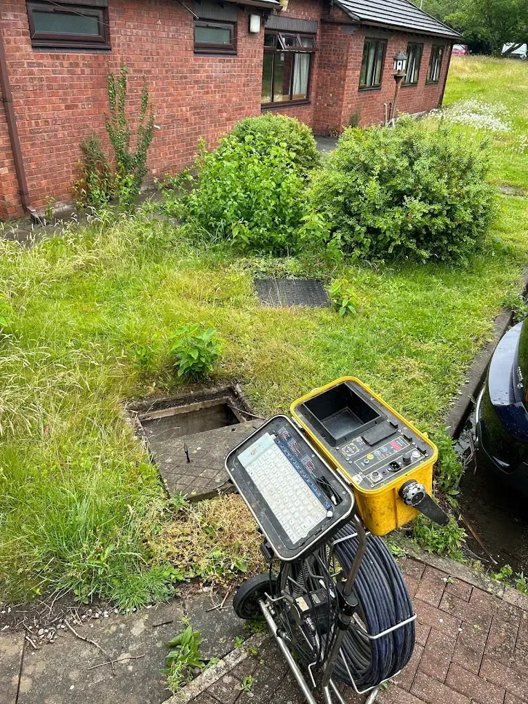 CCTV drain survey camera unit ready for inspection near a house